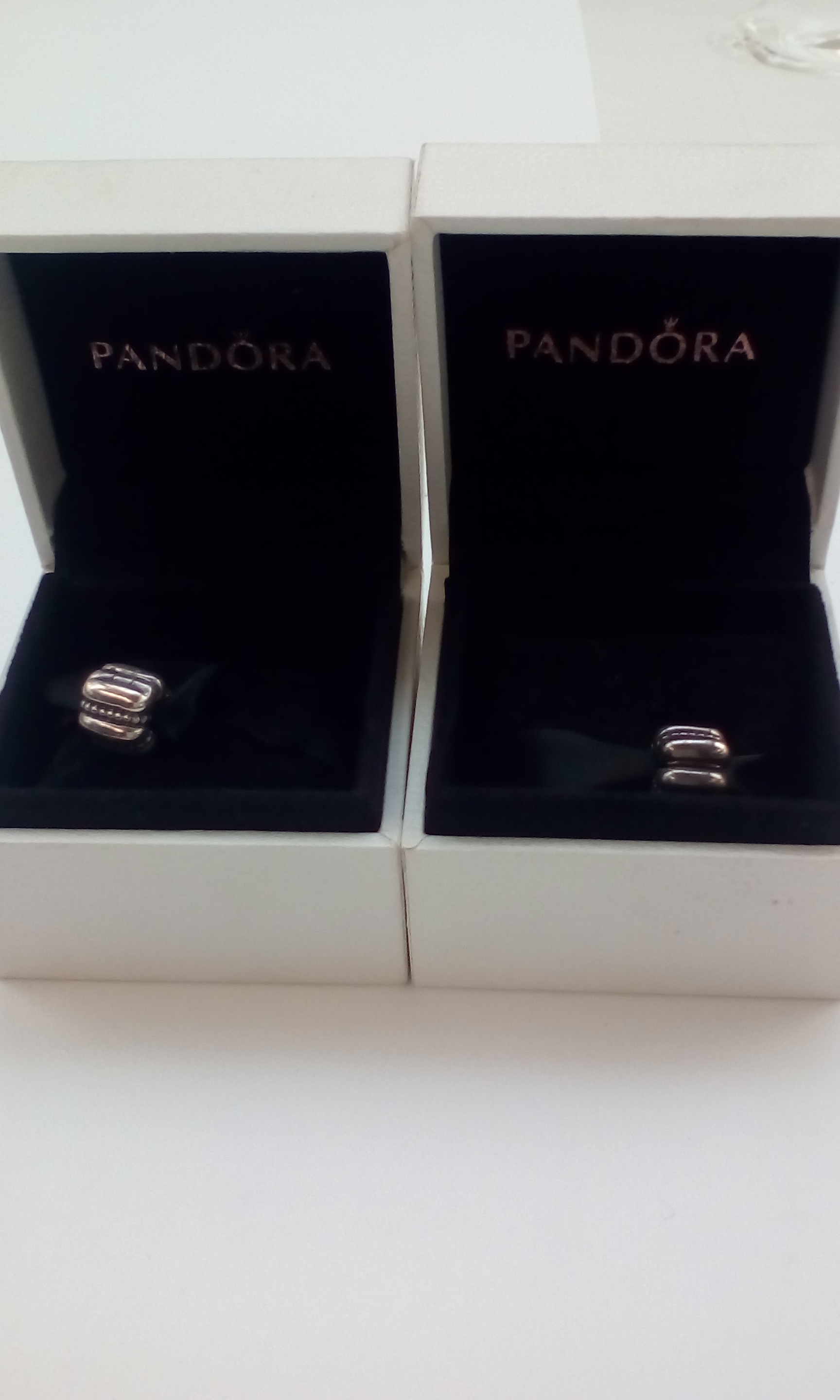 Two Pandora charms, boxed