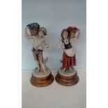 Pair of Florence figures on plinth bases, largest