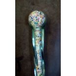 A twisted glass walking stick molded around what c