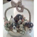 Lladro group, modelled as three dogs in basket, a/