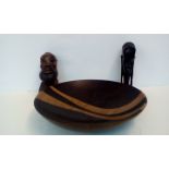 Two ethnic busts together with a treen bowl