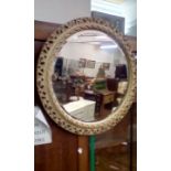 Circular wall mirror with pierced frame and bevel