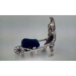 Silver pin cushion in the form of an elf pushing a