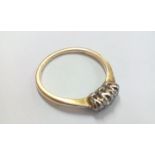18 carat gold ring set with three diamonds, size M