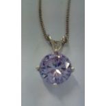Silver necklace and pendant set with purple gemsto