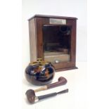 Oak smokers cabinet containing two pipes and lidde