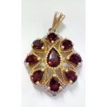 9 carat gold pendant set with garnets and chip dia