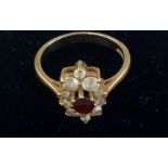 9 ct gold dress ring, central red stone and 13 sur