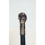 Walking stick with stylised skull finial