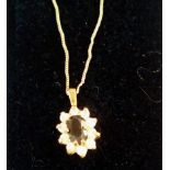 9 ct gold necklace, pendant with central red stone