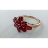 9 carat gold dress ring set with red gemstones, si