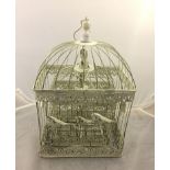 A graduated set of three wire metal bird cages