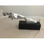 An aluminium Jaguar model on wooden stand