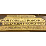 Five wooden street signs: Portobello Road, Camden Passage, Saville Row,