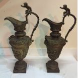 A pair of 19th century bronze ewers with cherubs to handles and body