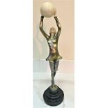 An Art Deco-style figure of a girl holding a ball