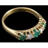 An 18ct diamond and emerald dress ring