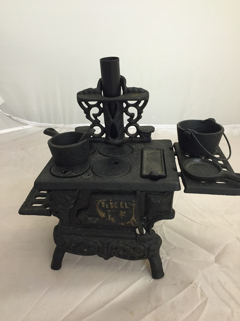 A cast-iron miniature stove and utensils