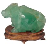 A Carved Green Hardstone Recumbant Water Buffalo: Crisp carving of a Water Buffalo with front leg