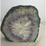 A large polished cut cross-section of amethyst