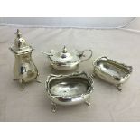 A hallmarked silver cruet set: pepperette,