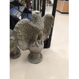 A stone garden ornament in the form of an eagle