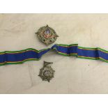 A breast badge and medal in silver,