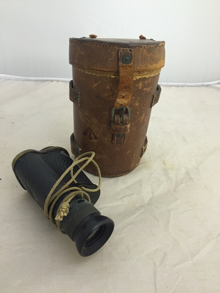 A military stamped monocular and case