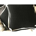 A set of four cableknit Ralph Lauren cushions