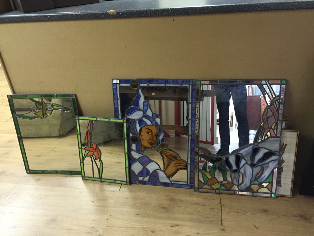 Four stained glass mirrors depicting a jester,