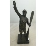 A bronze figure of an aviator/pilot