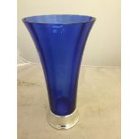 A blue glass vase with a HM silver base,