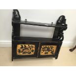 An ebonised wall cabinet with bird painted to panel doors