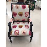 A fauteuille French-style chair upholstered with pansy patterned print