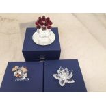 Three boxed Swarovski flowers to inc one in a vase