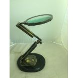 A large magnifying glass on stand by Watts & Sons Ltd