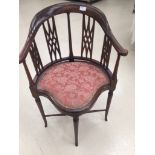 An Edwardian mahogany corner chair