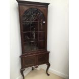 An edwardian mahogany corner cabinet