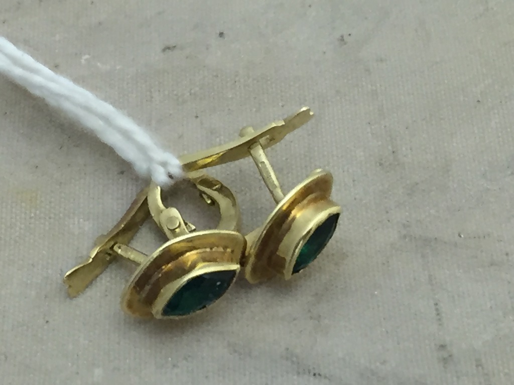 A pair of marquise cut emerald and gold earrings