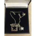 A diamond set star pendant on an 18ct chain