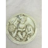 A resin roundel of three children