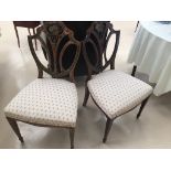 A pair of shieldback chairs,