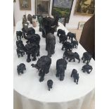 A large collection of ebonised elephants