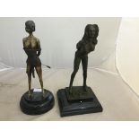 A pair of bronze ladies in erotic poses