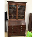 A 19th century mahogany bureau/bookcase with four graduated drawers