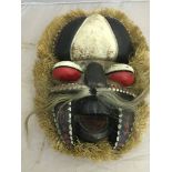 An African straw-fringed mask