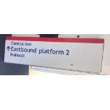 A Central Line overhead enamel "Eastbound Platform to Hainault" sign