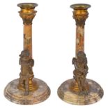 A Pair of Grand Tour Marble Candlesticks: With gilt decoration surmounted by bronze winged cherubs,