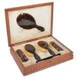 A Tortoiseshell Dressing Set in Leathered Box: A six-piece tortoiseshell dressing set comprising