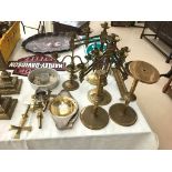 A quantity of brass candlesticks, crosses etc.